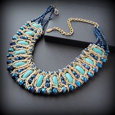 A vintage blue bib necklace is a statement piece for any occasion. Metal: gold-tone Stone - blue stone and glass beads Size -  '' + extender chain Signed - Kaymen Around the  2000s Condition - good condition PLEASE NOTE: Vintage jewelry can show signs of wear and discoloration or chipped metal consistent with age. Please look at the pictures carefully. Most were purchased at estate sales, auctions, etc. so they could need cleaning. If you need additional pictures or have questions, please contact me prior to purchase. I am not a jeweler or an expert. I do the best I can to research and represent the items. Also on auction purchases, I use the information I get from the auction houses. If you have any questions or need additional pictures, please let me know. Jewelry is sent first class in Gold Bib Necklace With Colorful Beads, Blue Jeweled Necklaces For Party, Blue Jewel Necklaces For Parties, Blue Jeweled Party Necklaces, Vintage Blue Choker Jewelry, Blue Bohemian Necklaces For Party, Blue Beaded Choker For Party, Costume Jewelry Beaded Choker Necklace, Blue Crystal Necklaces For Party