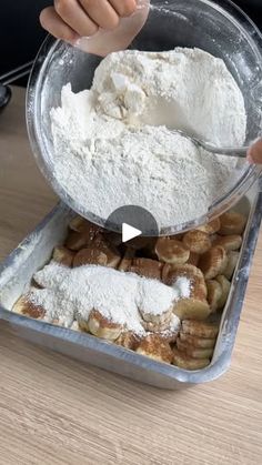 someone is mixing flour in a pan on a table with other food items around it