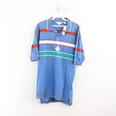 Vintage 80s Striped Color Block Short Sleeve Polo Shirt Polo Shirt New With Tags Mens Size Large Measurements Are: 22 Inches Underarm To Underarm 27 Inches Top To Bottom Blue Striped Cotton Check Out My Other Items In My Store! T283 Vintage Blue Collared T-shirt, Retro Blue Polo Collar T-shirt, Retro Blue Collared Top, Blue Retro Collared Tops, Blue Collared Retro Tops, Retro Spring Polo Collar Tops, Retro Short Sleeve Polo Shirt For Spring, Blue Retro Short Sleeve Tops, Retro Collared T-shirt For Spring