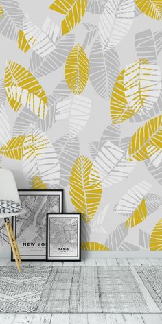 the wallpaper in this room is painted with yellow and grey leaf prints on it