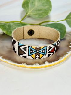 The adorable Aztec print leather cuff bracelet. Made in the USA. This bracelet is the perfect accessory for any womens wardrobe.  This bracelet is a great womens gift. Due to the assorted nature of this item, unique variations in color and print yield one-of-a-kind bracelet. The bracelet you receive may vary in style, print, and color from what is pictured. Southwestern Brown Bracelets, Southwestern Adjustable Leather Bracelet Gift, Southwestern Adjustable Leather Bracelet For Gift, Southwestern Adjustable Leather Bracelet, Multicolor Leather Bracelets, Trendy Multicolor Leather Jewelry, Southwestern Adjustable Cuff Bracelet, Adjustable Southwestern Cuff Bracelet, Multicolor Leather Bracelets As A Gift