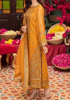 Introducing our New collection 'PYAAR DIYAN GALLAN' by Asim Jofa designed to make you look and feel your best. Immerse yourself in a sunlit meadow with this delightful sunshine-infused masterpiece. The mustard-hued shirt boasts embroidery that bursts with the joy of a harvest festival, embellished with warm honey-toned sequins accented by antique gold zariwork. This intricate artistry elevates the airy organza, transforming it into a canvas that radiates warmth like a summer sun. Paired with an embroidered, flowing dupatta featuring beautiful motifs, matches the regalia of the shirt with its serenity, unlocking a cultural treasure reimagined for the modern women. Embroidered Center Panel On Organza. Embroidered Side Panels Right and Left On Organza. Embroidered Border For Front Daman On Or Bohemian Orange Dress With Dupatta, Orange Bohemian Dress With Dupatta, Spring Festive Orange Dress, Yellow Summer Kurta For Festive Occasions, Unstitched Festive Summer Dresses, Summer Anarkali Dress With Dupatta, Summer Festive Lawn Suit With Dabka Detailing, Summer Festive Lawn Suit With Dabka, Summer Festive Lawn Suit With Dabka Embroidery