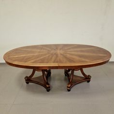 an oval wooden table with two pedestals on each side