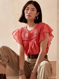 Soft with delicate pintucks, our lightweight ruffle-sleeve top is semi-sheer and made from 100% cotton for luxurious summer-day charm.  SWING FIT: Cut for a flowing, A-line fit.  No waist definition.  Crew neck with button-keyhole at back.  Straight Summer Tops With Ruffles And Flutter Sleeves, Summer Ruffle Top With Flutter Sleeves, Summer Ruffle Sleeve Blouse, Feminine Tops With Smocked Bodice And Flutter Sleeves, Feminine Top With Smocked Bodice And Flutter Sleeves, Casual Pintuck Short Sleeve Tops, Casual Short Sleeve Tops With Pintucks, Cotton Smocked Top With Flutter Sleeves For Spring, Summer Feminine Blouse With Ruffle Sleeves