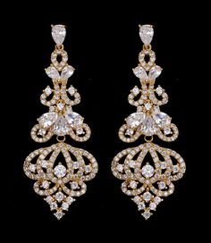 Gold Chandelier CZ Bridal Earrings This glamorous wedding and formal earring features dazzling AAA quality cubic zirconium (CZ) teardrop and round crystals in a unique gold plated chandelier design. These earrings will provide both sparkle and style to your wedding day, quinceanera or any special occasion. For pierced ears. Size: Earrings Measure 2 1/4" Long and 7/8" wide. Color: Light Gold/Clear. Style: e1002. Also a beautiful earring choice for your bridesmaids! Please allow 1 week for deliver Cubic Zirconia Bridal Earrings, Regal Wedding, Prom Fashion, Formal Earrings, Dangle Earrings Wedding, Gold Chandelier Earrings, Dazzling Earrings, Platinum Rose Gold, Zircon Earrings