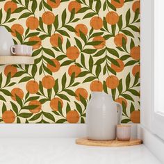 an orange and green wallpaper with some vases on the counter next to it