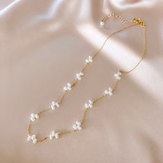 This delicate freshwater bead pearl necklace stands on it's own as a classic wardrobe staple and can be layered with any necklace.Handmade and attached to a delicate 14k gold-plated chain.Adjustable length "16-18". Dainty Pearl Necklace For Layering With Pearl Chain, Dainty Pearl Necklace For Layering, Dainty Double Strand Pearl Necklace With Charm, Layering Pearl Necklace With Delicate Chain, Delicate Pearl Necklace For Layering, Pearl Layered Necklace With Pearl Charm For Gifts, Pearl Charm Layered Necklace Gift, Pearl Necklace With Adjustable Chain For Layering, Delicate Double Strand Pearl Necklace With Charm