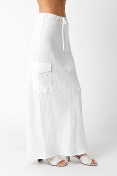 The Kaia White Linen Cargo Maxi Skirt is the perfect vacation cover-up! White linen woven fabric shapes this cargo maxi skirt with a mid-rise fit and drawstring tie. Style with sandals and a cute top and wear to dinner! DETAILS & FIT Loose Fit. 100% Linen. Machine wash cold. Imported. Summer Beach Bottoms With Cargo Pockets, Linen Lined Skirt For Vacation, Drawstring Midi Skirt For Summer, Relaxed Linen Maxi Skirt For Vacation, Linen Long Skirt For Vacation, Linen Skirt For Vacation, Long Linen Skirt For Vacation, Vacation Wide Leg Maxi Skirt For Beach Season, Vacation Beach Maxi Skirt Wide Leg