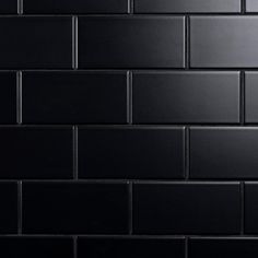 a black brick wall that is very dark in color and looks like it could be used as a background