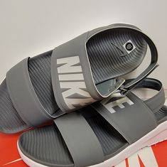 Nike Womens Tanjun Sandals Sz 12 Gray Gray Flat Sandals For The Beach, Comfortable Gray Sandals For Summer, Sporty Sandals With Ortholite Insole For Summer, Gray Flat Sandals For Spring, Gray Open Toe Beach Sandals, Gray Open Toe Sandals For The Beach, Ortholite Insole Slip-on Sport Sandals For Summer, Gray Sandals For Summer Vacation, Nike Sandals With Cushioned Footbed And Round Toe