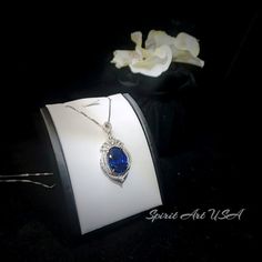 "Large Blue Sapphire Jewelry High Quality unique Artisan design full sterling silver made Gorgeous Luxury Gemstone Dainty Necklace best gift for yourself & you loved her. ◆◆Pendant Main stone:18*13mm Created Blue Sapphire Pendant Height ( include bail) : 41mm Pendant Holder (bezel & Bail) : White Gold Coated 925 Sterling Silver Accent Stone: Sim Diamond ◆◆ Necklace chain : Platinum coated 925 sterling silver Box Chain with length option from 16\" ~20\". The model wearing the default size Luxury Sapphire Oval Necklace, Luxury Oval Sapphire Necklace, Oval Blue Diamond Necklaces, Blue Oval Diamond Necklaces, Elegant Blue Hallmarked Necklace, Elegant Sapphire Oval Pendant Necklace, Blue Diamond Oval Pendant Necklace, Elegant Sapphire Necklace With Oval Pendant, Luxury Sapphire Oval Jewelry