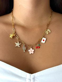 The cutest Ace of Spades charm necklace. This necklace features a stunning flower charm at its core, a turtle charm, a star charm, a cactus charm, a cherry cham, an ace of spades card charm, and a moon charm. nd star charm. This charm necklace is the perfect combination of coquette and dainty for an everyday look. If you would like to switch out any of the charms, feel free to message to personalize! Trendy Star Charm Pendant Jewelry, Cute Dangle Charms Jewelry, Trendy Pendant Jewelry With Dangling Charms, Cute Dangle Charm Necklaces With Lobster Clasp, Trendy Dangle Charm Necklaces With Lobster Clasp, Cute Dangle Charm Necklaces For Jewelry Making, Starfish Charm Pendant Necklace Gift, Starfish Charm Pendant Necklace For Gift, Gift Starfish Charm Pendant Necklace