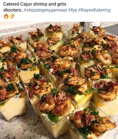 several trays filled with shrimp and grits sitting on top of a marble counter