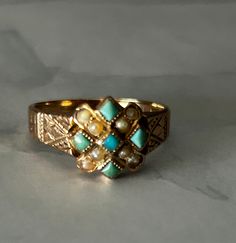 This is a antique Victorian ring in 10k rose gold. This ring has seed pearls and turquoise stones. Ring has initials VRF etched inside ring. Ring is in good condition with only age related wear. Ring is a size 7.5. Ring isn't marked 10k but was tested. Victorian Turquoise Jewelry For Anniversary, Turquoise Victorian Jewelry For Anniversary, Antique Yellow Gold Turquoise Ring For Anniversary, Heirloom Hallmarked Yellow Gold Turquoise Ring, Antique Yellow Gold Turquoise Ring Gift, Antique Turquoise Ring In Yellow Gold For Gift, Vintage Yellow Gold Turquoise Ring For Anniversary, Antique Patina Ring, Vintage Yellow Gold Turquoise Ring Hallmarked