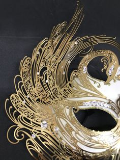 Venetian Mask for decoration - Traditional and original papier-mache Venetian mask, handmade and decorated with metal insert, gold-leaf and glitters,enriched with Swarovski crystals. Dimension: All our masks are handmade papier-machè masks made in Venice. Our decorators use techniques typical of the Venetian tradition such as stucco, acrylics, gold and silver-leaf, macramè, passementerie, glitters and crequelè to offer you a wide range of original handmade masks and decorations This shape is ava Artistic Gold Masquerade Mask For Costume, Vintage Gold Masquerade Mask For Carnival, White Venetian Masquerade Mask As Gift, White Venetian Masquerade Mask For Gift, Vintage Gold Eye Mask Masquerade, Artistic Masquerade Mask For Halloween Party, Artistic White Eye Mask For Masquerade, Artistic Handmade Masquerade Mask For Costume Party, Handmade Artistic Masquerade Mask For Costume Party