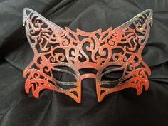 This hand-drawn designed 3d printed mask is great for Halloween, masquerade parties, renaissance fairs or just your own fun photoshoot! It's lightweight, comfortable and formed to the face. Just a touch of spirit gum keeps it in place (not included) or a ribbon tie (included.)  Available in matte, gloss, glitter, red & black, orange & black (pictured above), white & black (for an arctic fox look) or any combination of crazy colors you want. Handmade Masquerade Mask For Halloween Cosplay, Adjustable Halloween Eye Mask, Fantasy Halloween Masks, Themed Masquerade Costume Mask, Novelty Masks And Prosthetics For Halloween Masquerade, Fantasy Masks For Carnival, Fantasy Masks For Carnival Events, Themed Masquerade Mask For Carnival Cosplay, Adjustable Fantasy Masquerade Mask For Costume