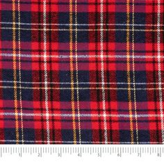 a red and blue plaid fabric is shown with a measuring ruler in front of it