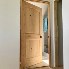 an open door leading to a bathroom in a house