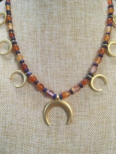 "Ancient style Lunula or Crescent moon necklaces with a variety of genuine gemstone options! Beautiful 22k gold plated pendants to compliment your ancient Roman, Greek, Parthian, Coptic or any other Bronze age persona! You can wear them with your prettiest T shirt and jeans outfit. Earrings that compliment these necklaces can be found in my Etsy shop here. https://www.etsy.com/listing/817662134/ancient-style-lunula-crescent-mooref=shop_home_active_2 These necklaces are finished with 14k gold fil Celestial Crescent Jewelry For Healing, Artisan Crescent Jewelry Hand Forged, Artisan Hand Forged Crescent Jewelry, Bohemian Crescent Necklaces For Jewelry Making, Celestial Crescent Jewelry For Meditation, Celestial Crescent Necklaces For Healing, Spiritual Crescent Jewelry For Jewelry Making, Celestial Style Gold Necklace With Natural Stones, Celestial Gold Jewelry With Round Beads