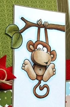 a card with a monkey hanging from a tree branch