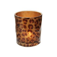 a leopard print candle holder with a light inside the middle, on a white background