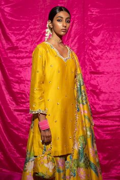 Yellow chanderi silk kurta with sequin, pearl placement embroidery. Paired with floral print sharara and fringe bordered dupatta.
Components: 3
Pattern: Printed, Embroidery
Type Of Work: Floral, sequin, pearl
Neckline: Scallop V neck
Sleeve Type: Long sleeves
Fabric: Chanderi Silk, Lining: Shantoon
Color: Yellow
Other Details: 
Fringe tassel bordered dupatta
Length:
Kurta: 35 inches
Sharara: 38 inches
Note: Potli shown in the image is not for sale
Occasion: Sangeet - Aza Fashions Floral Print Sharara, Placement Embroidery, Printed Embroidery, Kurta Set For Women, Silk Kurta, Tassel Fringe, Kurta Set, Set For Women, Aza Fashion