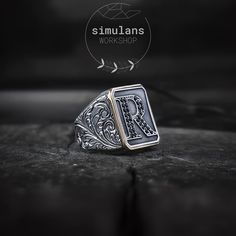 Elevate your style with our customizable initials sterling silver men's ring, meticulously designed to combine timeless elegance with a personal touch. Crafted from high-quality 925 sterling silver, this ring features a rectangular design adorned with intricate engravings, showcasing the art of gravure. Material: 925 Sterling Silver Design: Rectangular format with customizable initials or monograms Details: Embellished with black micro stones for a sophisticated finish Finish: Antique finish for Luxury Silver Initial Ring, Classic Silver Initial Ring With Monogram, Silver Monogram Signet Ring For Formal Occasions, Timeless Silver Rings With Initials, Luxury Silver Initial Ring Hallmarked, Black Sterling Silver Signet Ring With Engraving Option, Luxury Silver Hallmarked Initial Ring, Classic Black Customizable Jewelry, Classic Sterling Silver Monogram Rings