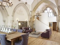 a large living room filled with furniture and chandeliers