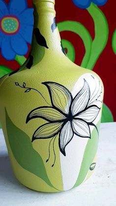 a painted vase sitting on top of a table