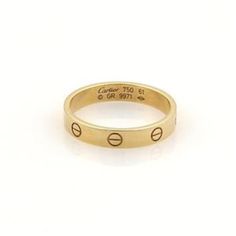 This is an authentic band ring by Cartier, this beautiful authentic designer ring is crafted from 18k yellow gold with a fine polished finish and comes from Cartier's famous LOVE collection in the mini style. It is a piece of absolute style and substance and has full designer hallmark and metal content with serial number.  Material:  18k yellow gold.     Hallmark:  Cartier 750 61 GR9971 Measurements: Band is: 3.5mm wide  Ring Size:  US: 9.75  European: 61 Weight: 4.7 grams Stock#: 51154 Designer Rose Gold Rings For Anniversary, Classic Yellow Gold Engraved Couple Rings, Luxury Yellow Gold Bands For Gift, Designer Polished Gold Rings, Designer Gold Ring With Polished Finish, Designer Gold Rings With Polished Finish, Designer Yellow Gold Diamond Ring For Anniversary, Luxury 14k Yellow Gold Bands, Designer 14k Rose Gold Rings