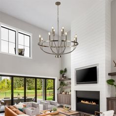 a living room filled with furniture and a flat screen tv mounted on the wall above a fireplace