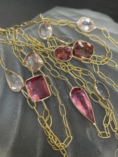 The necklace has 12 gorgeous natural tourmalines of multiple shapes and hues from dusty pink, peach pink to white, and ligth pink. The tourmalines are bezeled in solid 14K yellow gold on a beautiful textured oval link chain. They are ranging from size 1 carat to 3 carats each, and 10mm at the wides. The gold links are 5x3mm Lobster clasp marked 14K I designed and made this item in my shop, and take custom requests! Please feel free to reach out with inquiries! Fine Jewelry Pink Multi-stone Necklace, Pink Morganite Jewelry With Gemstone Accents, Pink Tourmaline Jewelry With Gemstone Accents, Pink Faceted Tourmaline Jewelry, Pink Morganite Gemstone Necklace, Ligth Pink, Natural Gemstone Jewelry, Long Beaded Necklace, Pink Peach