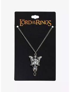 the lord of the rings necklace is shown in front of a card with an image of a