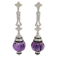 Amethyst 69.95 carats with Diamond 2.11 carats and Pearl Earrings set in 18 Karat White Gold Settings Width: 1.7 cm Length: 7.4 cm Total Weight: 33.17 grams "We first opened doors in 1980 when it was then situated in the vicinity of the Victory Monument; a small and modest storefront with a couple of counters. From its humble beginnings to where it stands today, our company has proven its abilities as a jeweler. Since the beginning, we have been supplying fine quality pieces to dealers, wholesal Luxury Formal Earrings With Gemstone Accents, Formal Amethyst Gemstone Earrings, Luxury Amethyst Earrings For Formal Occasions, Amethyst Earrings Fine Jewelry For Formal Occasions, Amethyst Gemstone Earrings For Formal Occasions, Elegant Amethyst Earrings For Formal Occasions, Purple Fine Jewelry Earrings For Formal Occasions, Luxury Purple Earrings For Evening, Formal Briolette Earrings With Gemstone Accents