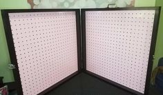 an open room divider with polka dots on the wall and black carpeted floor