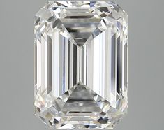 an emerald cut diamond is displayed on a gray background, with the center stone visible