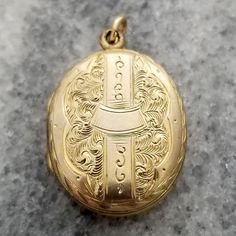 This is a lovely finely detailed antique oval shaped locket. The front and back are decorated in intricate etched designs. It opens up to reveal a compartment perfect for two photos. The locket measures 1 1/8 inch (29.33mm) tall, including loop 11/16 inch (19.22mm) wide It is unmarked but appears to be yellow gold filled. It weighs 3.5 grams It is in good wearable condition, it does show some signs of wear from being a piece of vintage estate jewelry. All it needs is a chain to hang from (chain in photos not included). Please inspect photos closely before purchasing. This item will be shipped fully insured in the US. Just send me a message if you have any questions. Oval Locket, Etched Designs, Victorian Design, Locket Necklace, Estate Jewelry, Locket, Halloween Shopping, Gold Filled, Accessory Gift