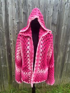 A cropped hooded hexagon cardigan in various shades of pink, offering an oversized and cozy fit suitable for up to an extra-large size. This piece can be safely machine washed on a gentle cycle and dried on low heat. Pink Hand Knitted Spring Outerwear, Spring Pink Hand Knitted Outerwear, Spring Hand Knitted Pink Outerwear, Pink Bohemian Crochet Outerwear, Pink Crochet Outerwear For Winter, Handmade Pink Outerwear For Spring, Casual Handmade Pink Outerwear, Handmade Pink Cardigan For Fall, Handmade Pink Spring Outerwear