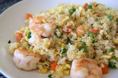 rice with shrimp and peas on a white plate