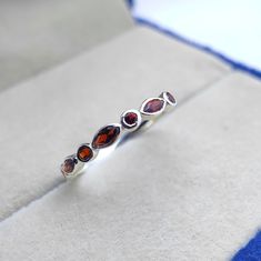 Tiny delicate vintage art deco garnet wedding ring, Small & dainty sterling silver marquise cut garnet womens wedding band, Garnet jewelry ------------------------------------------------------------------------------------------------------------------------------------------------------------------------------------------------------------- Garnet Wedding Ring ◈ Item Details ◈ Metal : Sterling Silver Metal Purity: 925 Parts Per 1000 Style : Vintage Ring Main Stone : Natural Garnet  Stone Size : 2x4 mm Stone Shape : Marquise  Other Stone : Garnet  Occasion : Party , Anniversary , Wedding Personalization : Possible 925 sterling silver with silver/white/yellow/rose gold plated. Sent in a very elegant wedding ring box, ready for one special lady. Customization is always welcome and please fe Elegant Marquise Sterling Silver Ring, Dainty Marquise Gemstone Jewelry, Dainty Marquise-cut Jewelry As A Gift, Dainty Marquise Cut Jewelry As Gift, Dainty Marquise Cut Jewelry For Gifts, Elegant Garnet Stackable Rings, Elegant Red Garnet Stackable Rings, Elegant Adjustable Gemstone Stackable Rings, Adjustable Marquise Jewelry For Formal Occasions