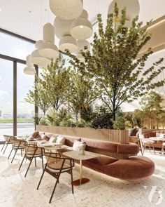 the interior of a restaurant with tables, chairs and lamps hanging from the ceiling above