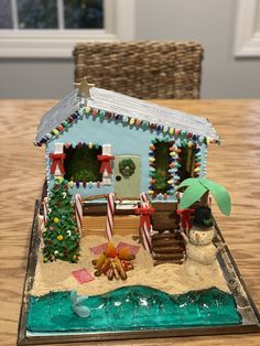 a gingerbread house decorated for christmas on a table