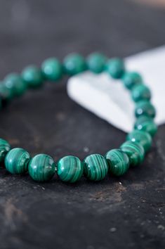 Wear your Malachite bracelet every day to remember that you are powerfully creating the life you desire. You are on a path of change, growth & transformation and it's beautiful how far you've come. Malachite is a stone of change, transformation, and growth. It encourages risk-taking, letting go of old stories that no longer serve you, and breaking free from ties that keep you from evolving. Releasing negative experiences and old traumas, this crystal is truly a stone of personal freedom! AAA Mal Spiritual Malachite Bracelets With 8mm Beads, Spiritual Malachite Beaded Bracelets With Gemstone Beads, Spiritual Malachite Beaded Bracelets For Healing, Spiritual Malachite Beaded Bracelet For Healing, Adjustable Malachite Spiritual Bracelet, Adjustable Spiritual Malachite Bracelets, Adjustable Spiritual Malachite Bracelet, Spiritual Malachite Bracelets As Gift, Spiritual Malachite Bracelet As A Gift