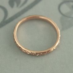 At a dainty 2.4mm wide by 1.5mm thick, our Skinny Flourish Ring is the perfect thinner wedding band or stacking ring. You simply can't do without it! Pair it with your other stacking rings or wear it alone as a symbol of your love. It's a stunning band. It is hand cast just for you in our studio from solid 10K gold in your choice of color and meticulously hand polished to perfection. Also available in 14K gold here: https://www.etsy.com/listing/291070075 Blazer Arts is a family-owned and operate Yellow Gold Stackable Rings With Intricate Design For Wedding, Delicate Yellow Gold Engraved Wedding Ring, Delicate Engraved Rose Gold Ring For Wedding, Delicate Engraved Round Ring For Wedding, Rose Gold Rings With Decorative Band For Wedding, Delicate 14k Gold Wedding Bands, Heirloom Engraved Stackable Rings For Wedding, Delicate Engraved Round Wedding Ring, Delicate Engraved Wedding Ring