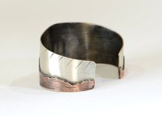 Handcrafted in our home away from home in Sedona, AZ, this cuff bracelet transforms lowering monoliths into wearable metal art. ► As shown, this bracelet ships in a stock 6.0 inch length to fit a medium wrist, however you can order your bracelet in any size by simply noting your preferences in the personalizations box. ►The bracelet measures approximately 1.5 inches wide in the center and 1 inch wide towards the ends of the bands. ► Sawed entirely by hand without following a guide, the 17 gauge Unique Adjustable Cuff Bracelet With Polished Finish, Artisan Silver Cuff Bracelet In Copper, Silver Artisan Cuff Bracelet In Copper, Artisan Silver Copper Cuff Bracelet, Artistic Copper Cuff Bangle Bracelet, Artistic Copper Cuff Bracelet, Bohemian Copper Cuff Bracelet With Patina, Artisan Silver-colored Copper Cuff Bracelet, Cathedral Rock