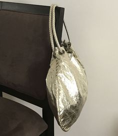 Attractive metallic gathered double-handle hobo bag.

Next-day processing. Shipped in 4-7 days. Gold Bucket Bag With Top Carry Handle, Gold Bucket Shoulder Bag With Top Carry Handle, Gold Shoulder Bucket Bag With Top Carry Handle, Gold Bucket Bag With Handles For Travel, Gold Bucket Bag With Double Handle, Silver Hobo Tote Bag With Removable Pouch, Gold Hobo Bag With Detachable Handle For Shopping, Gold Hobo Bag With Detachable Handle For Daily Use, Metallic Bags With Adjustable Strap For Daily Use