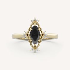 an oval shaped black diamond ring set in yellow gold with diamonds around the band and center stone