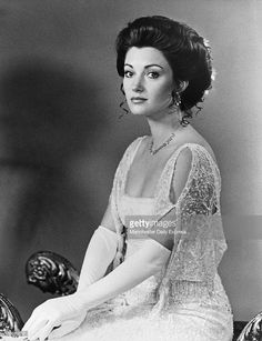 an old black and white photo of a woman sitting on a chair