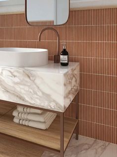 a bathroom with a marble sink and wooden counter top next to a mirror on the wall