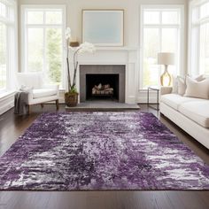 a living room filled with furniture and a purple rug on top of a hard wood floor